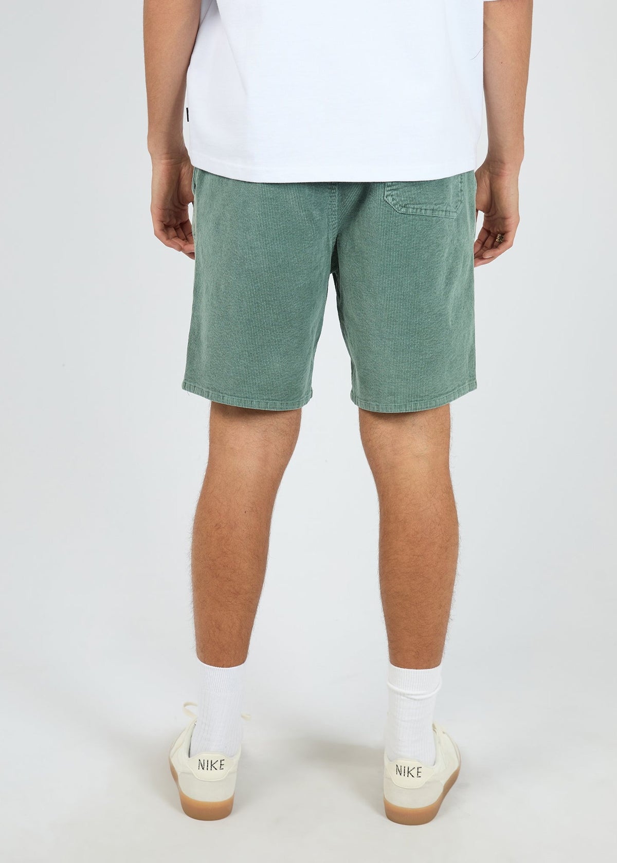 Back of the bottle green corduroy short showing the patch pocket